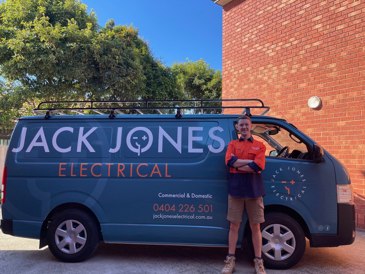 Jack from Jack Jones Electrical standing in front of the branded work van