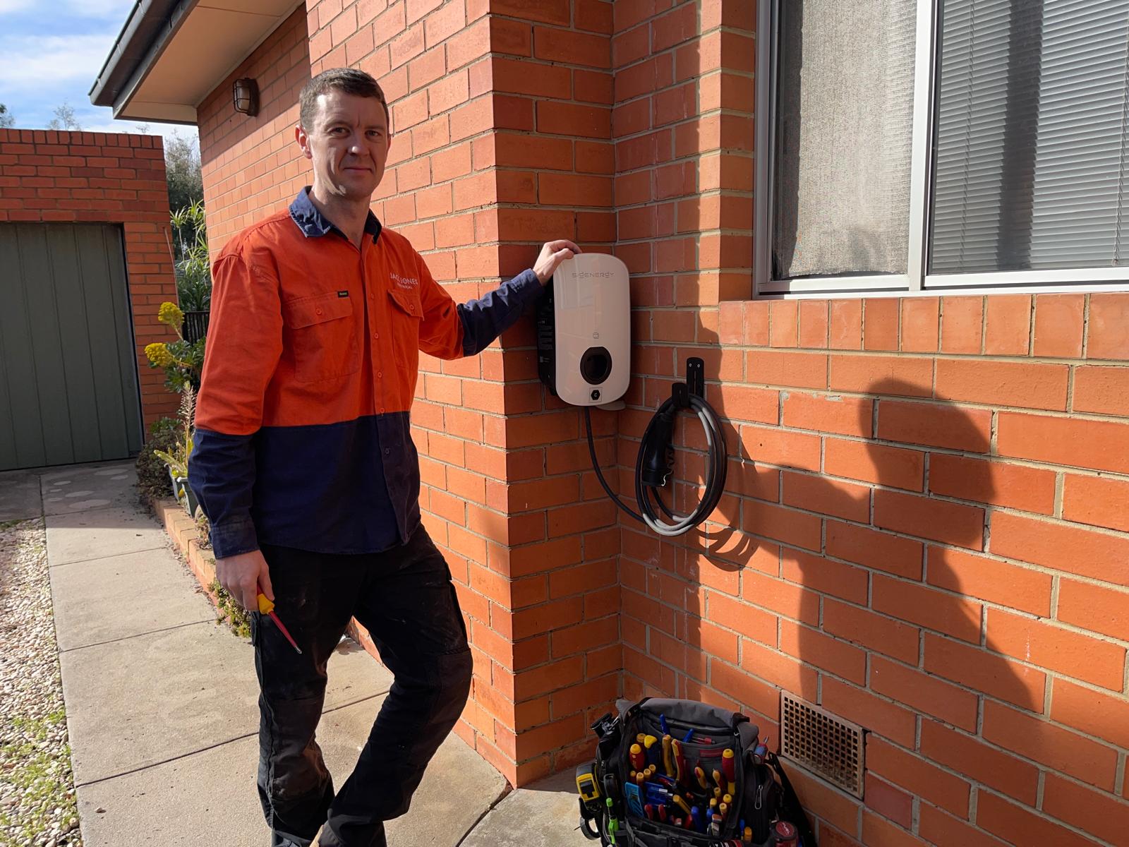 Sigenergy EV charger installed on a brick exterior wall by Jack Jones Electrical, bayside Melbourne