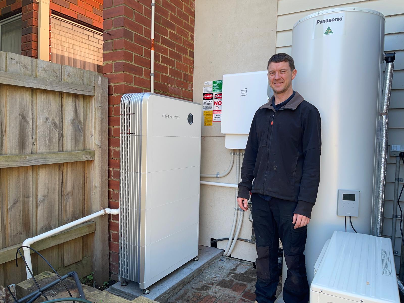 Jack Jones beside a Sigenergy SigenStor battery and hybrid inverter installed on a bayside Melbourne home